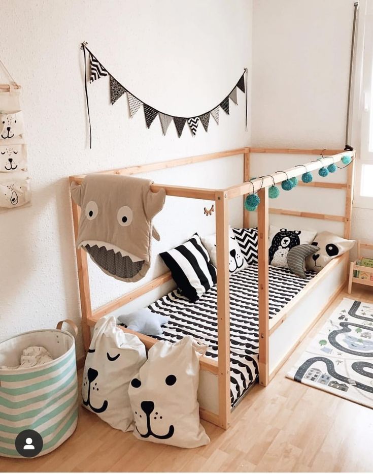 a child's bedroom with wooden bunk beds and animal themed decor on the walls