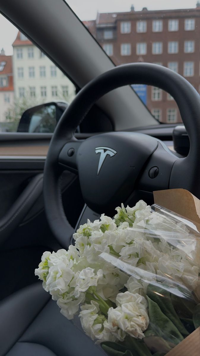 a bouquet of flowers sitting in the passenger seat of a car