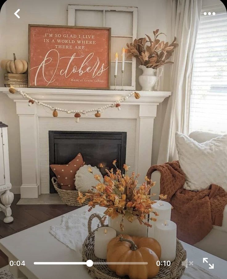 a living room filled with furniture and a fire place covered in pumpkins on top of a table