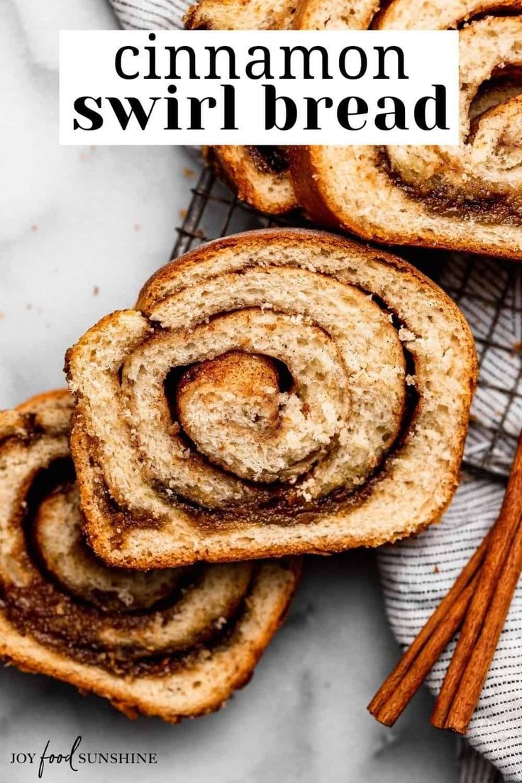 cinnamon swirl bread on a cooling rack with cinnamon sticks in the foreground and an image of cinnamon rolls behind it