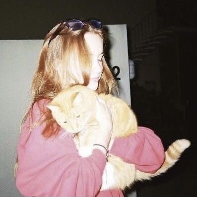 a woman holding a cat in her arms