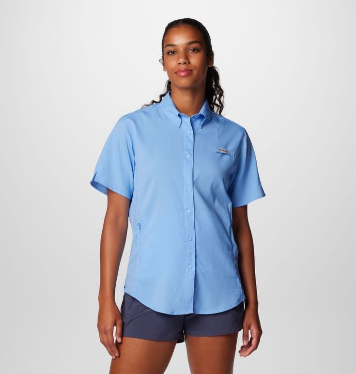 a woman wearing a blue shirt and shorts