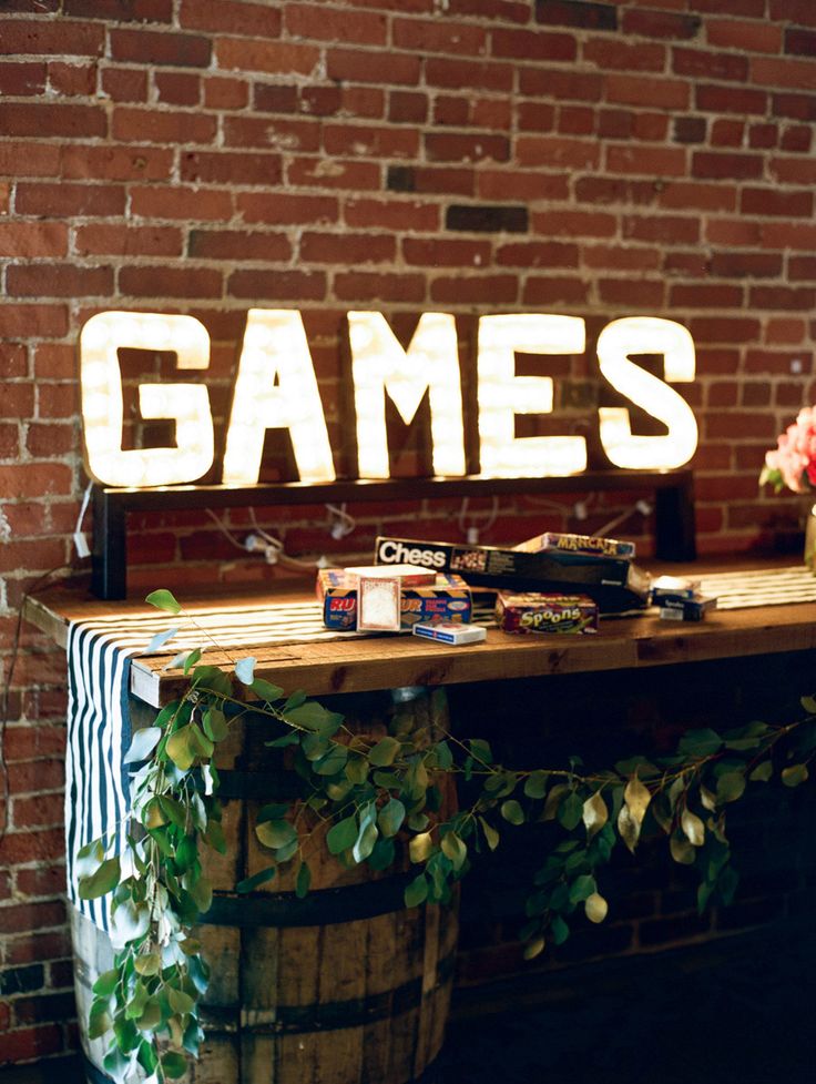 a wooden sign that says games sitting on top of a table