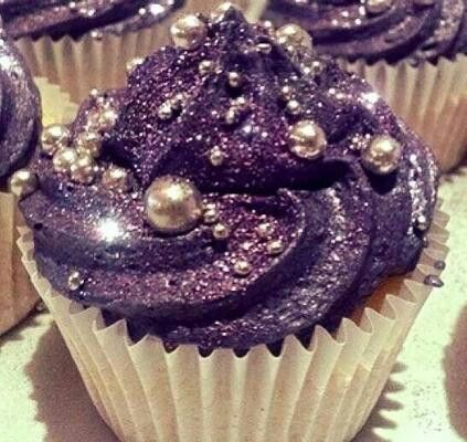 cupcakes with purple frosting and gold decorations