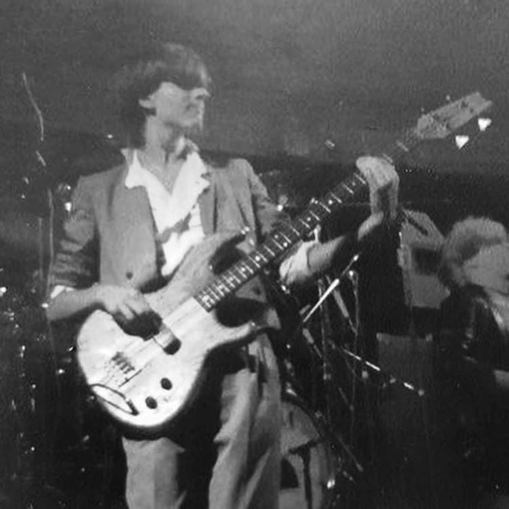 two men are playing guitars on stage