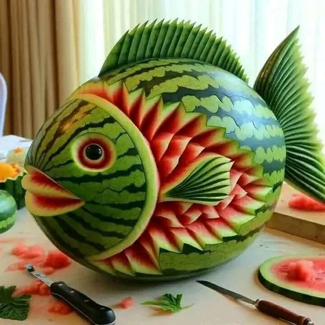 a fish made out of watermelon sitting on top of a table