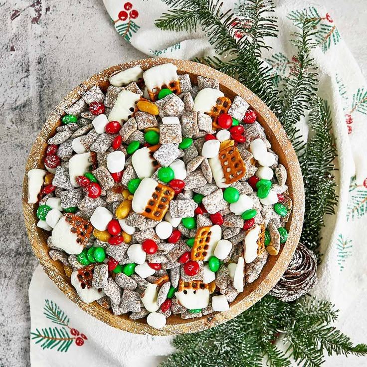 a bowl filled with candy and marshmallows on top of a white towel