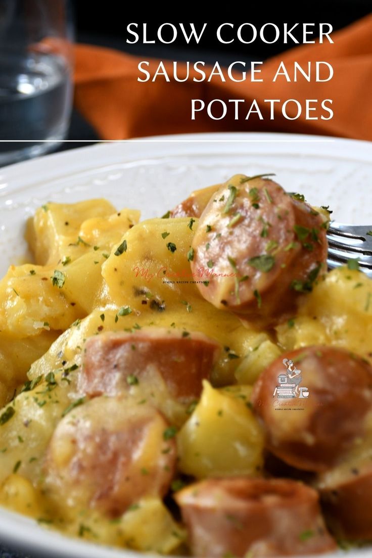 a white plate topped with sausage and potatoes