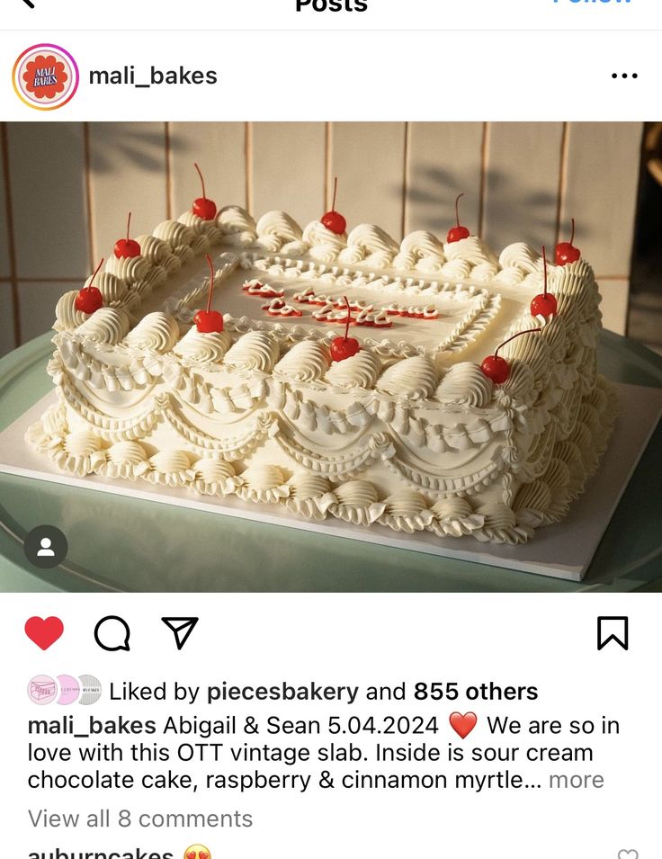 a cake with white frosting and red berries on top is displayed in an instagram