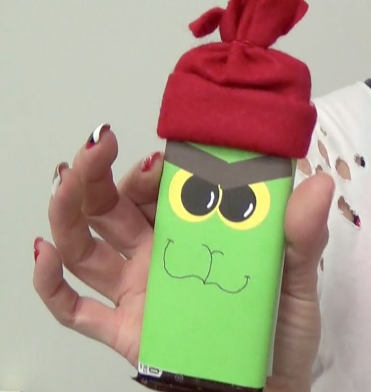 a woman holding up a cell phone case with an angry bird on it's face