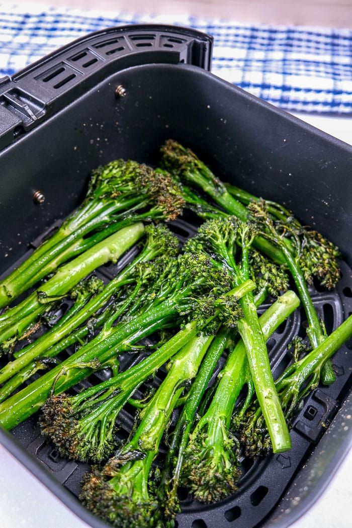 broccoli is in a black container on a table