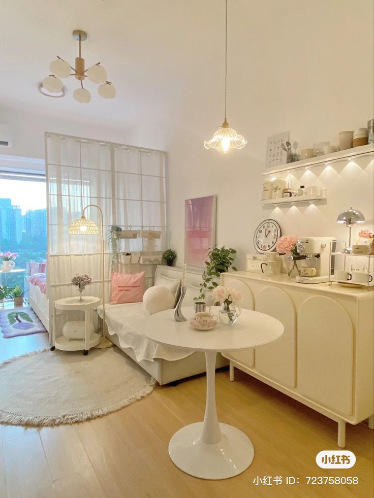 a living room filled with white furniture and lots of lights above the couches in front of a sliding glass door