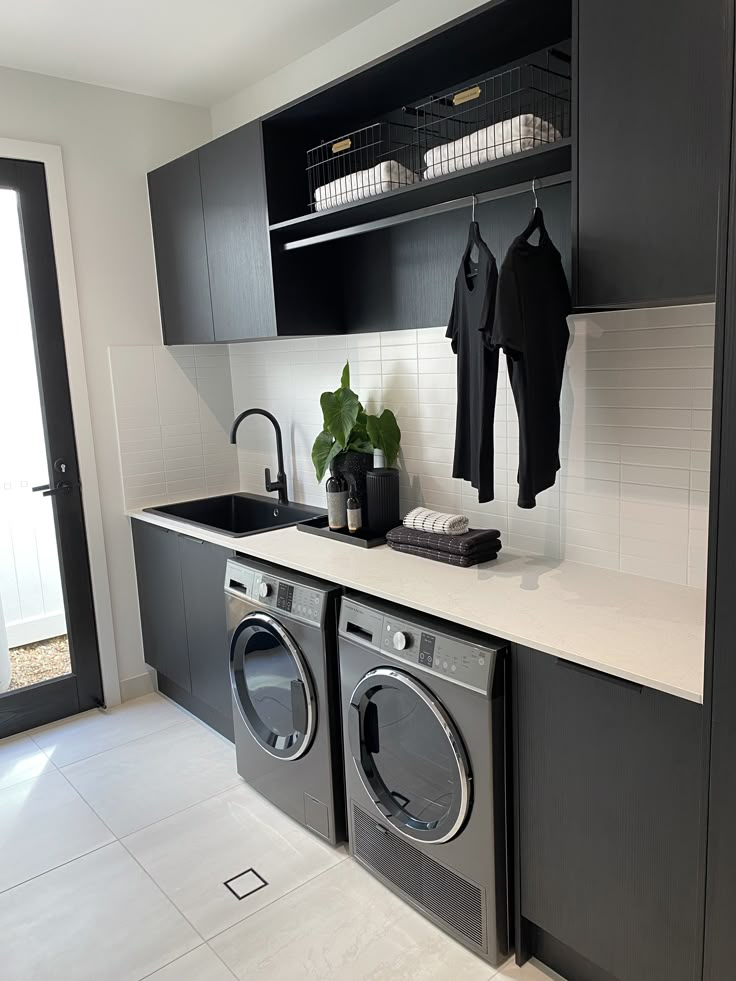 a washer and dryer sitting in a kitchen next to each other on top of a counter