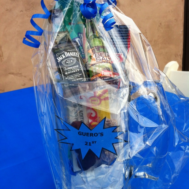 a basket filled with snacks and drinks on top of a blue table