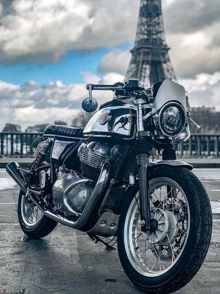 a motorcycle parked in front of the eiffel tower