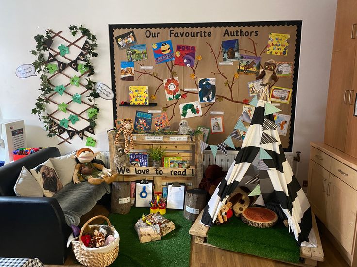 a child's room with toys and decorations on the wall, including teepee tents