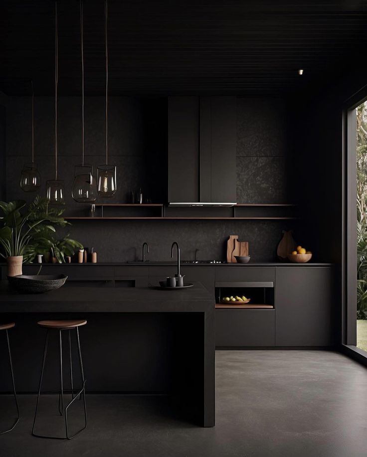 a kitchen with black walls and flooring next to a large window that looks out onto the outdoors