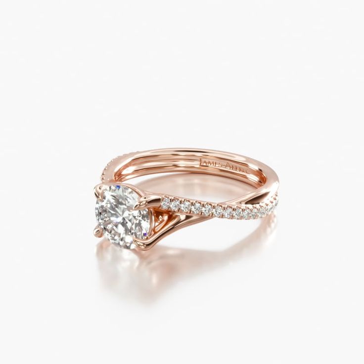 a yellow gold ring with a single diamond on the top, and a thin band around it