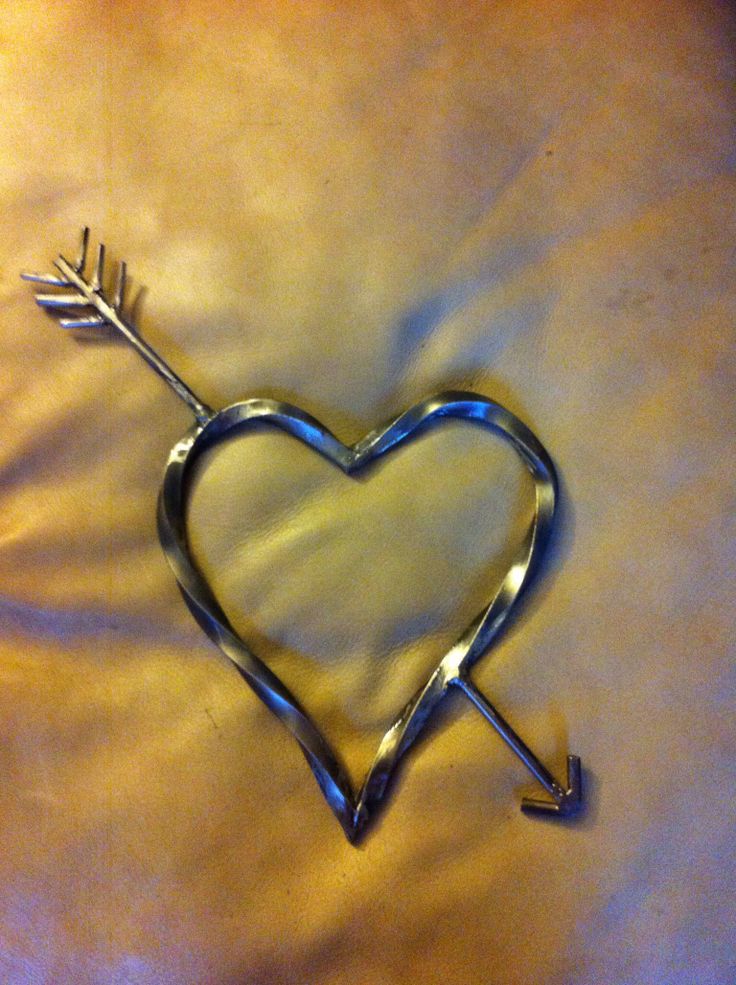 a metal heart with an arrow in the middle