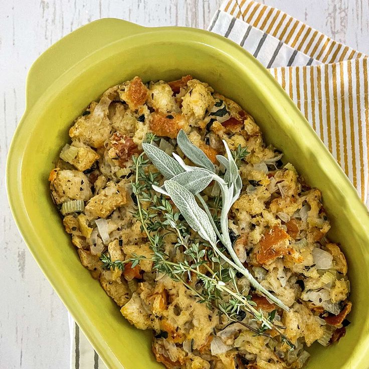 a green bowl filled with food on top of a table