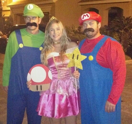 three people dressed up as mario bros and princess peach, with one person in a costume