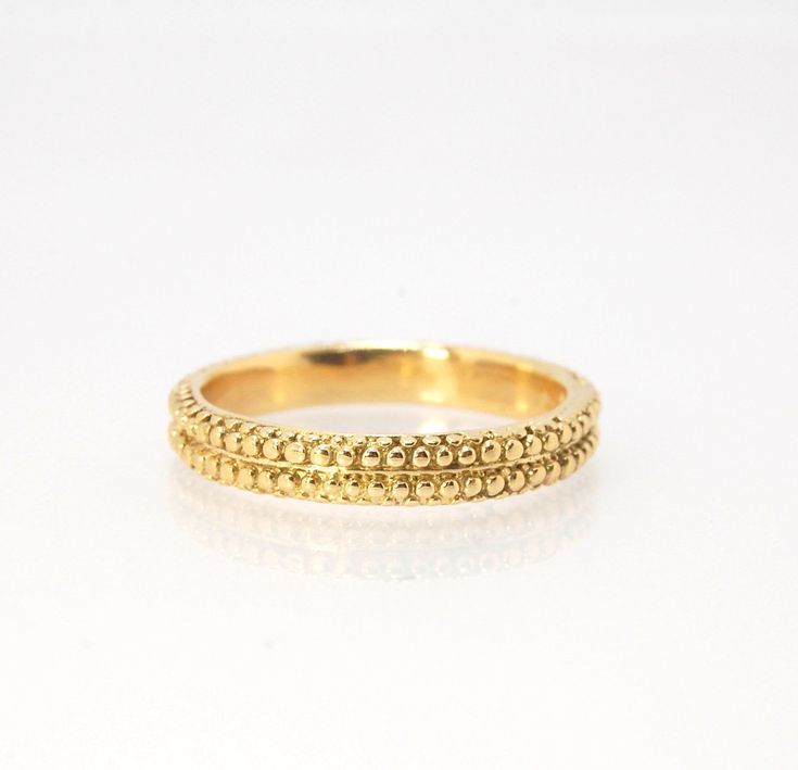 This is cast from a granulated original and is pictured in 14k yellow gold, but I can also cast this in Sterling or 18k yellow. Or would be happy to make a similar design for you in original 18k granulation!Granulation is a controlled fusing process that has been utilized for thousands of years. This unique surface will get more interesting with wear. The granules are individually placed and fused with a mouth torch. I then make a mold of the ring and pull a wax copy from that mold and cast it u Fine Jewelry Yellow Gold Nugget, Yellow Gold Nugget Fine Jewelry, Fine Jewelry In Yellow Gold Nugget Shape, Ceremonial 14k Yellow Gold Jewelry, Ceremonial Yellow Gold Fine Jewelry, 14k Stamped Yellow Gold Nugget Jewelry, Gold Round Band Jewelry For Ceremonial Occasion, Ceremonial Gold Round Band Jewelry, Ceremonial 14k Gold Jewelry With Diamond Cut