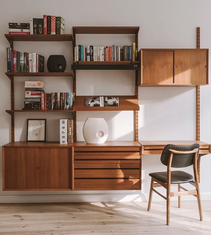 a room with a desk, bookshelf and chair next to the bookcase