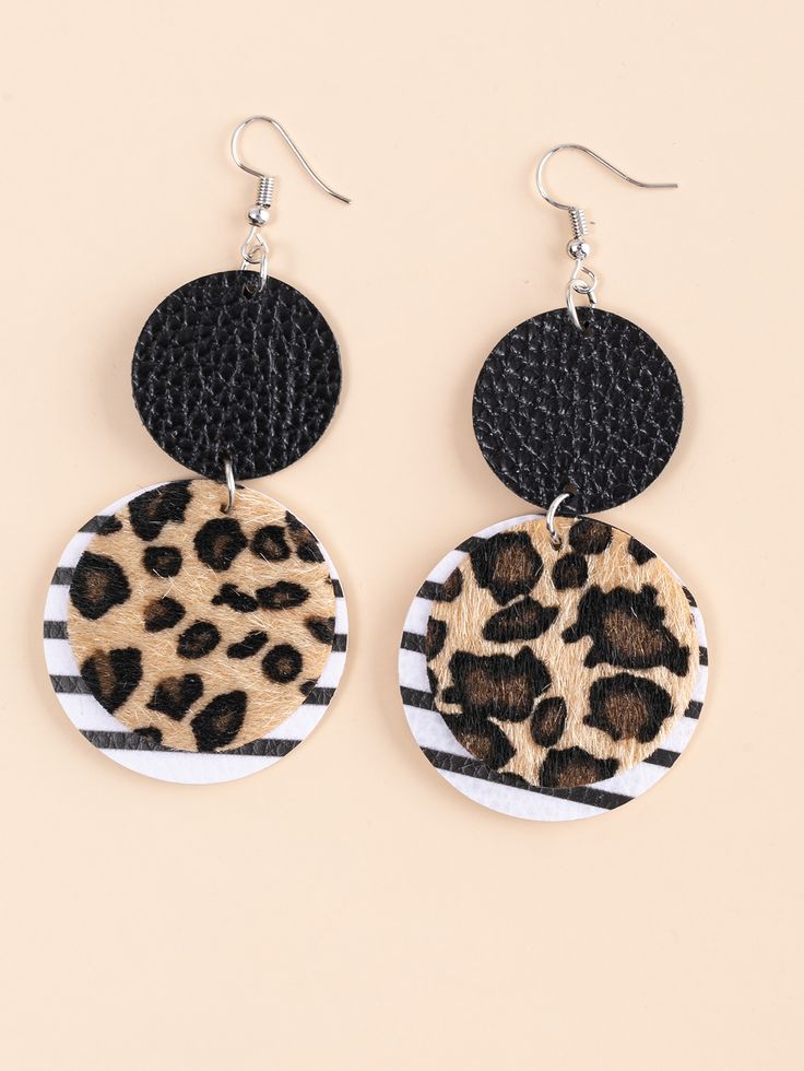 the leopard print and black leather earrings are shown on a beige background, with an animal print