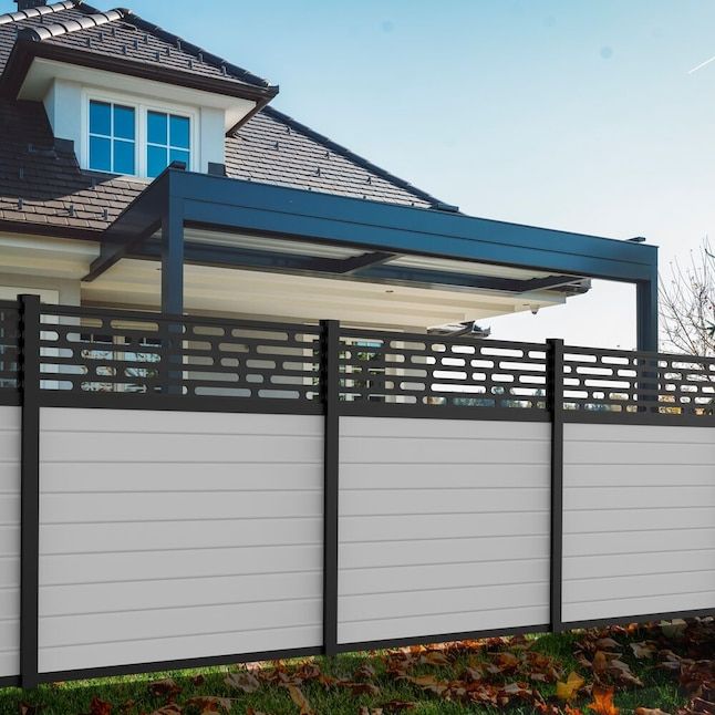 a white and black fence in front of a house