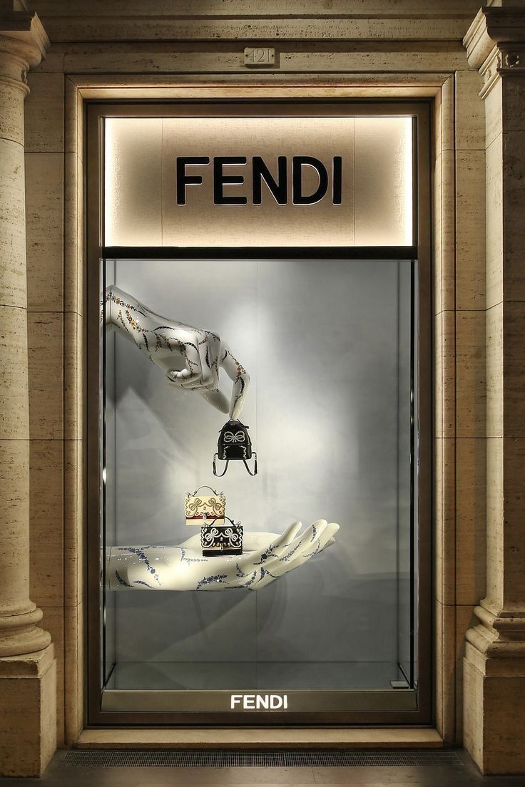 a display window with an image of a hand holding a purse