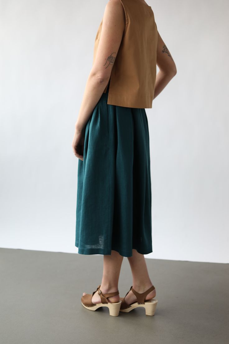 - Handmade in our studio from 100% linen - Full pleated skirt  - Buttons opening at the front side - Side pockets - Length off the skirt from the waist to the hem - 74 cm/29 in Linen Lined Skirt For Workwear, Green Linen Relaxed Fit Skirt, Summer Linen Midi-length Bottoms, Linen Pleated Long Skirt, Linen Pleated Skirt For Work, Workwear Linen Pleated Skirt Bottoms, Flowy Linen Pleated Skirt, Linen Midi Skirt For Work, Linen Green Lined Skirt Bottoms