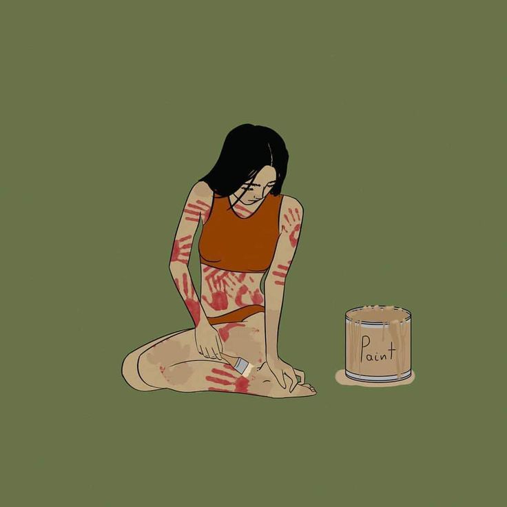 a woman sitting on the ground next to a can of peanut butter with her hands painted