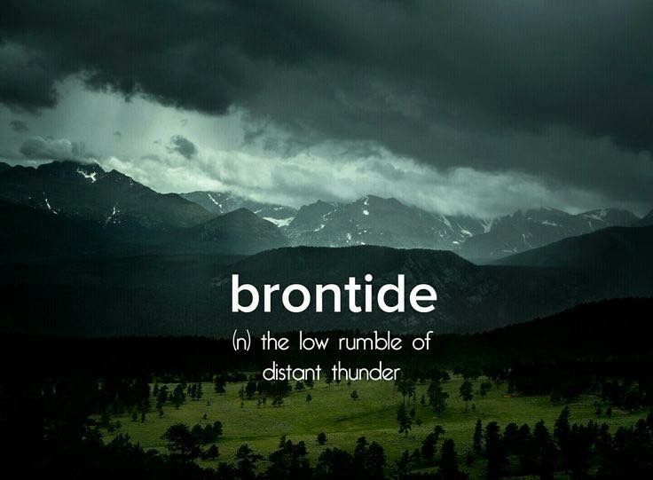 the words brontide in the foreground are dark and cloudy, with mountains in the background