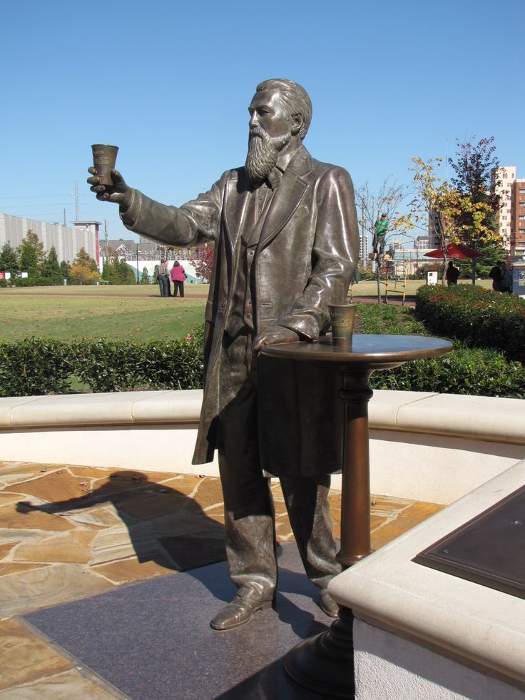 a statue of a man holding a cup