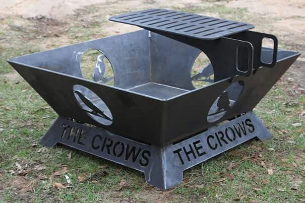 a black metal box with the words the crows on it sitting in grass next to dirt