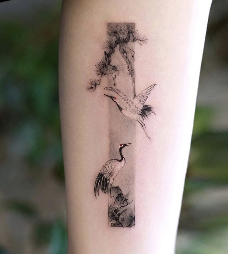 a woman's leg with a bird and flower tattoo on the left side of her arm