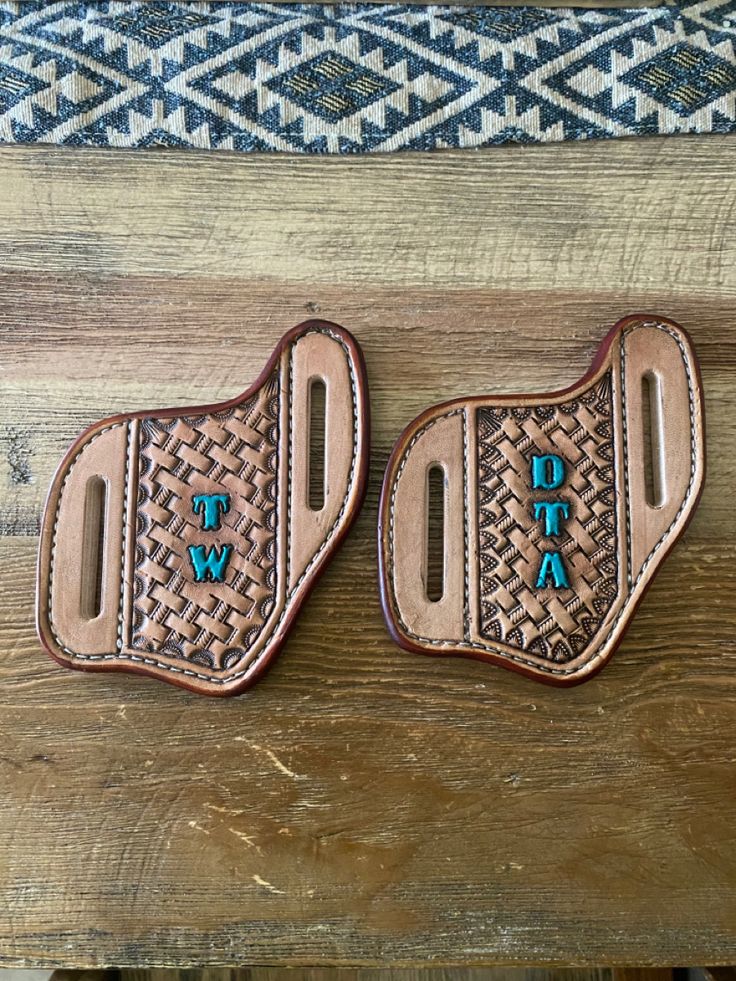 two brown leather holsters with the words tiwa on them