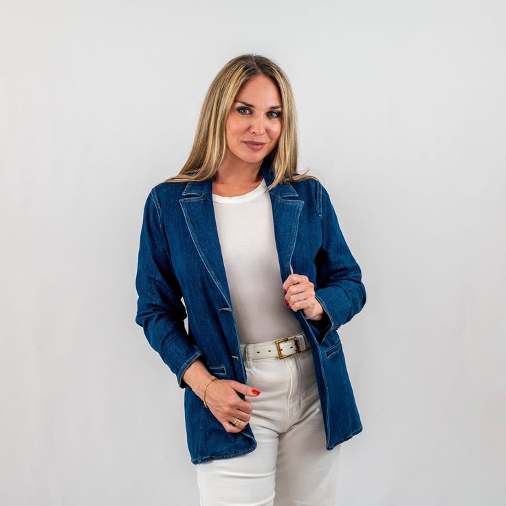 Discover the perfect blend of casual and polished with our chic structured denim blazer. Designed for the fashion-forward woman, this versatile denim jacket offers a sophisticated silhouette with notched lapels and a contemporary tailored fit. It's an ideal piece for those seeking a casual sophisticated denim blazer that transitions effortlessly from day to night. Affordable Spring Denim Blazer, Notch Lapel Denim Jacket For Workwear, Formal Denim Blazer For Spring, Spring Formal Denim Blazer, Classic Single Breasted Denim Blazer, Fitted Denim Blazer With Lapel Collar, Tailored Denim Notch Lapel Outerwear, Tailored Denim Outerwear With Notch Lapel, Fitted Denim Blue Outerwear With Notch Lapel