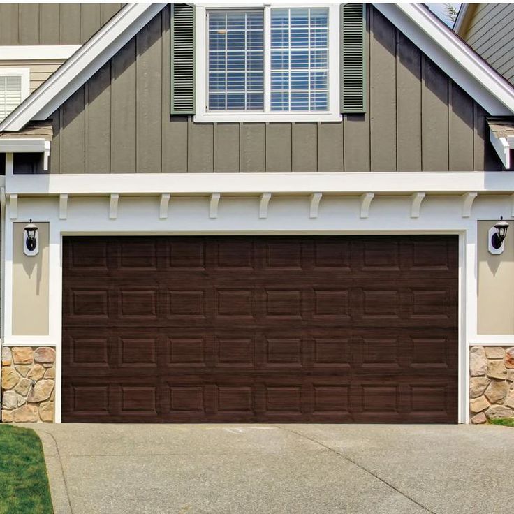 a brown garage door in front of a house