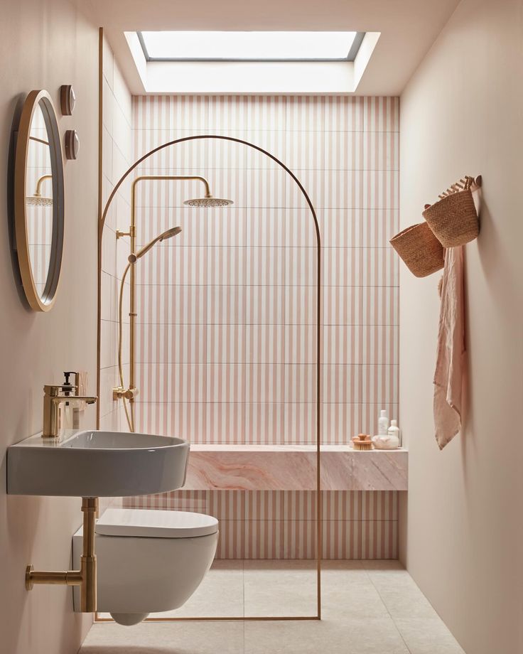 a bath room with a toilet a sink and a shower head mounted to the wall