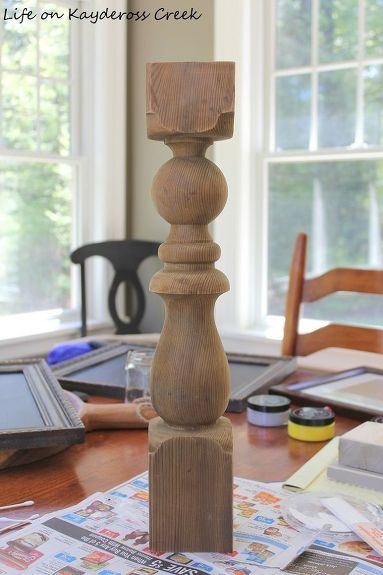 a wooden candle holder sitting on top of a table