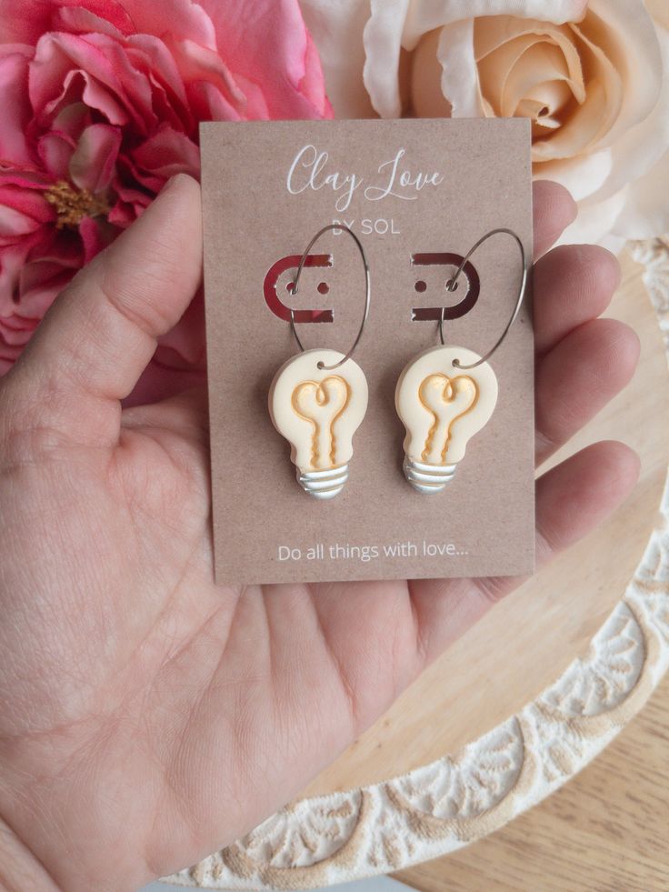 Back to school has never looked so fun! These Lightbulb Idea Polymer Clay dangle earrings are lightweight and with stainless steel hoops. Teachers have the best ideas that can be thought of in the spur of the moment, so what better way to show it than to be wearing them. Earrings are great conversation starters; the kids will love them and be proud their teacher is so cool!! Great teacher gift idea or addition to your earring collection if you’re a teacher. Level up your look this year! Nickel Free Novelty Earrings For Everyday Wear, Casual Hoop Earrings As Gift, Casual Small Hoop Earrings For Gifts, Novelty Dangle Earrings For Everyday, Novelty Everyday Dangle Earrings, Everyday Novelty Dangle Earrings, Casual Hoop Jewelry Gift, Casual Hoop Jewelry For Gift, Fun Everyday Dangle Earrings