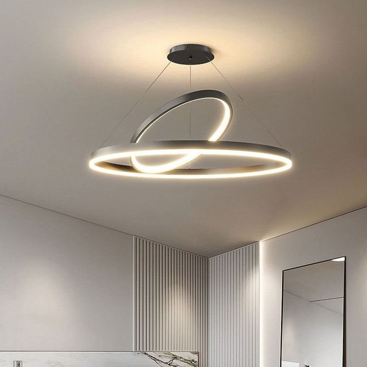 a bathroom with a circular light hanging from the ceiling