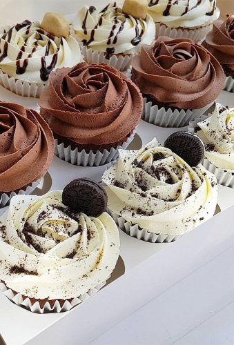 there are many cupcakes with chocolate frosting and oreo cookies on top