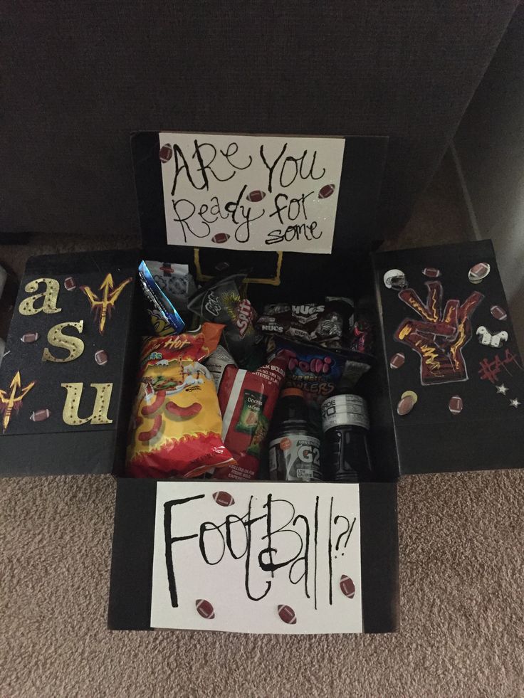 a football themed gift box filled with candy and personalized items for someone's birthday