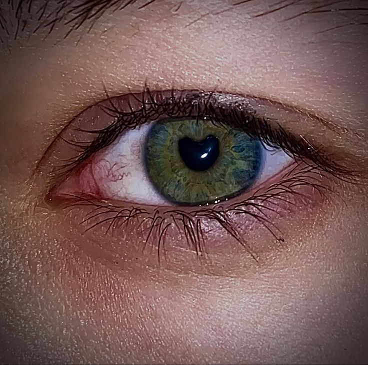 an eye with blue and green colored eyes is shown in this close up photo,