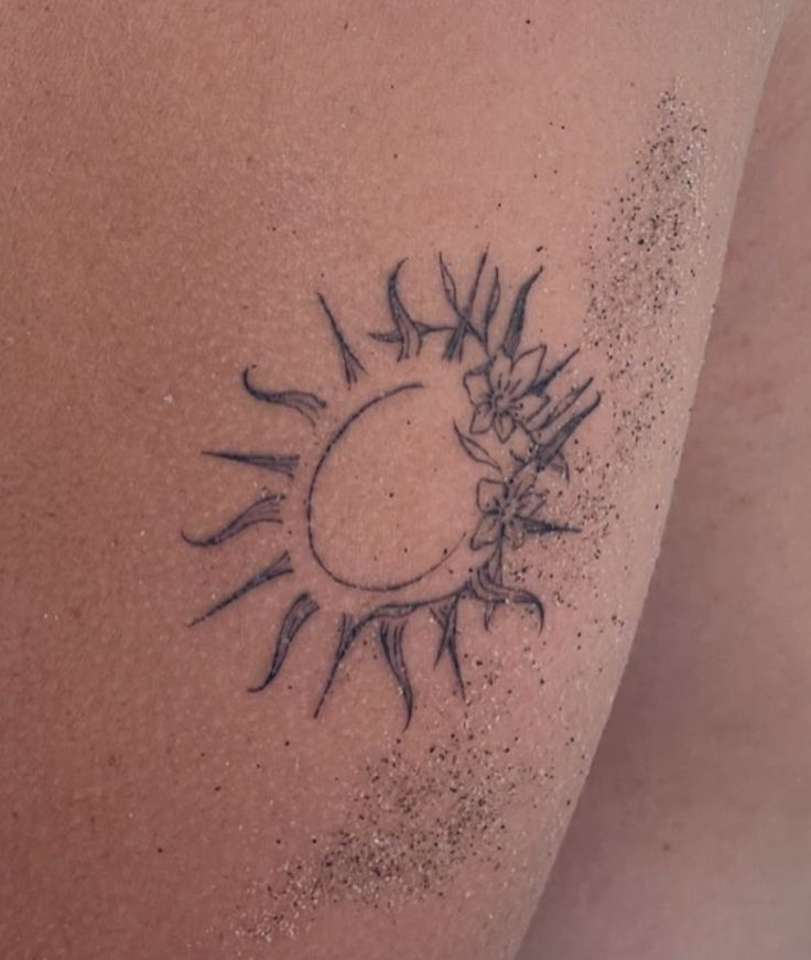 a close up of a person's back with sun and stars on the side