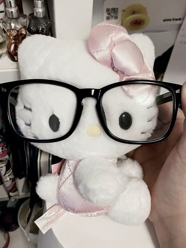 a hello kitty stuffed animal wearing glasses