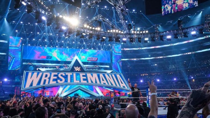 the wwe logo is displayed in front of an audience