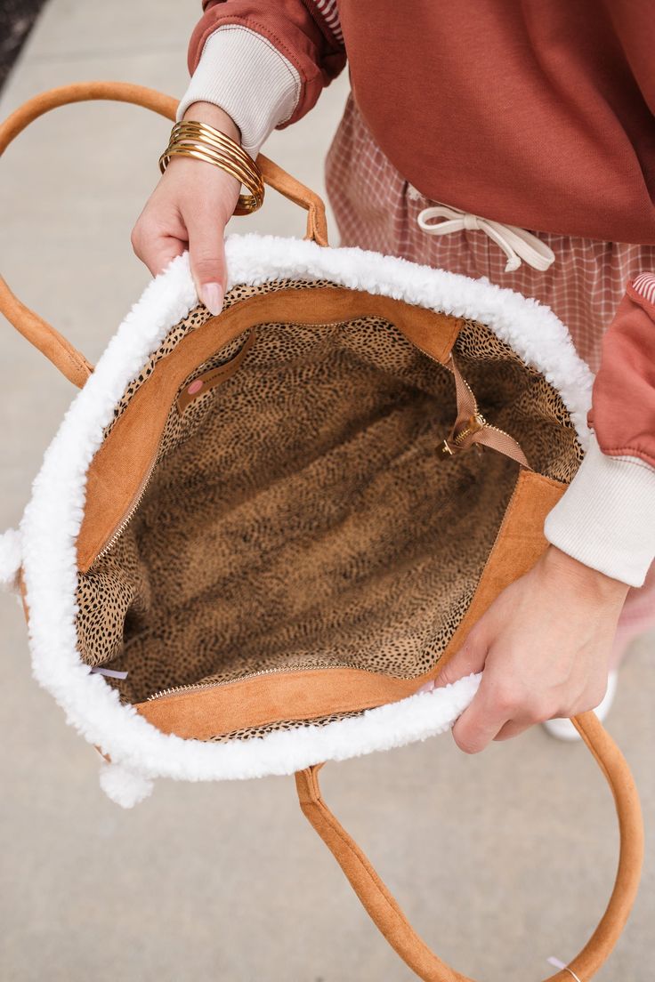 The IT bag for fall! Our Teddy Cozy Tote Shoulder Bag features trendy sherpa trim with zippered closure and a camel body. No pockets. Everyday Brown Winter Bag, Brown Everyday Bag For Winter, Winter Travel Brown Shoulder Bag, Winter Everyday Bags With Zipper Pocket, Winter Brown Shoulder Bag Satchel, Brown Winter Shoulder Bag Satchel, Winter Brown Satchel Shoulder Bag, Brown Shoulder Bag Satchel For Winter, Winter Brown Shoulder Bag With Double Handle